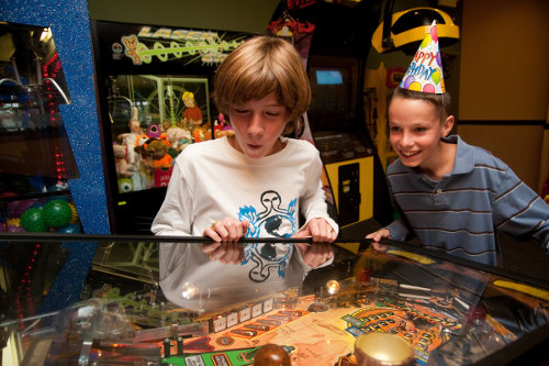 Boys playing pinball