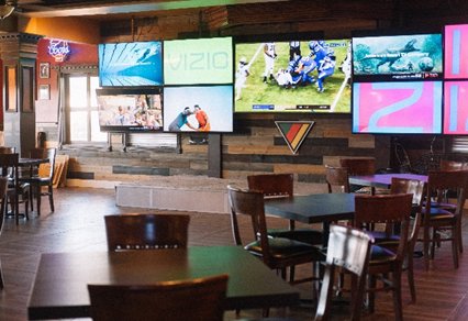 Interior of a store with a wall of big-screen TVs